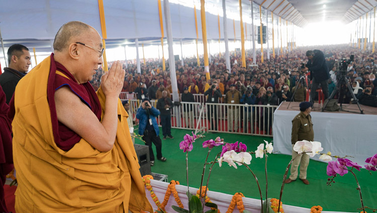 Seine Heiligkeit der Dalai Lama würdigt die Menschenmenge von über 50.000 bei seiner Ankunft im Kalachakra Maidan in Bodhgaya, Bihar, Indien am 5. Januar 2018. Foto: Lobsang Tsering