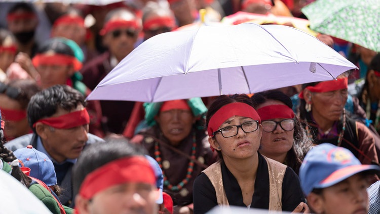 Die Teilnehmenden schützen sich mit Schirmen gegen die heisse Sonne während der Unterweisung von Seiner Heiligkeit dem Dalai Lama in Padum, Zanskar, J&K, Indien am 23. Juli 2018. Foto: Tenzin Choejor